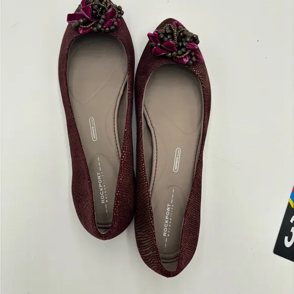 M344 New Women’s Rockport burgundy flats. Jeweled buckle.  Size 10. Very comfy.